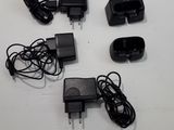 a lot of power cords and a charger on the table