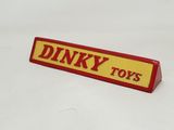 a red and yellow sign that says dinky toys on it