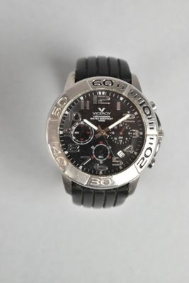 a close up of a watch on a white surface