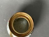 a small vase with a gold rim on a table