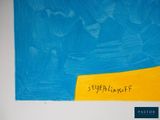 a blue and yellow painting on a wall with writing on it