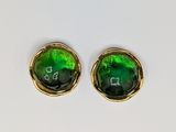 pair of green glass stud earrings with gold accents on a white surface