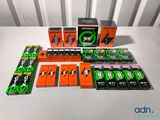 many different boxes of cigarettes on a white table