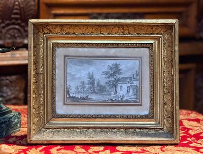 la photo d'une maison dans un cadre posé sur une table