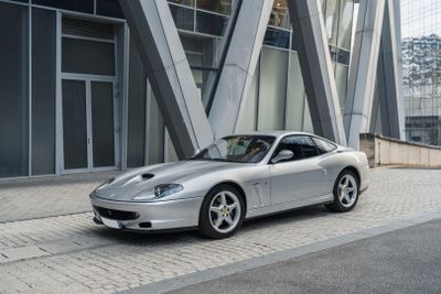a silver sports car parked in front of a building