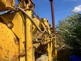 a large yellow machine that is sitting in the dirt