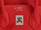 hermes ' s red leather handbag with a skull on the front