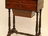 a small wooden table with a drawer on top of it