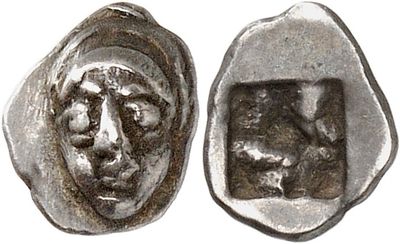a close up of a coin with a face on it