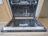 a dishwasher that is open in a kitchen