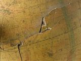 a large globe with a crack in the middle of it