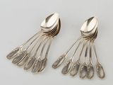 two spoons and two spoon spoons sitting on a table