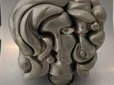 a sculpture of a woman ' s face on a table