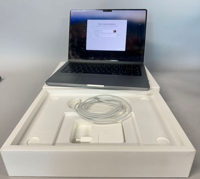 a laptop computer sitting in a white box on a table