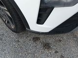 a close up of a car ' s front bumper with a hole in it
