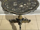 a black and gold table with shells on it