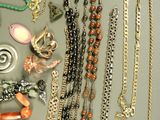 many necklaces and bracelets laid out on a table