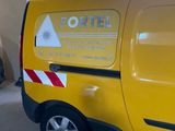 a yellow van that is parked in a garage