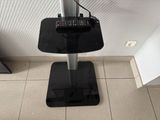 a remote control sitting on top of a speaker stand