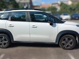a picture of a white car parked in a parking lot