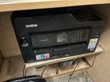 a printer and a mouse on a shelf in a room