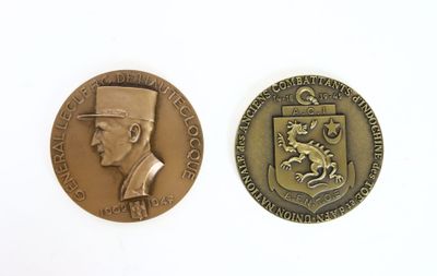 two medals with a man in a top hat and a dragon on them