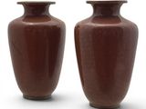 deux vases marron posés côte à côte sur une surface blanche