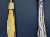 three spoons and a knife on a black surface