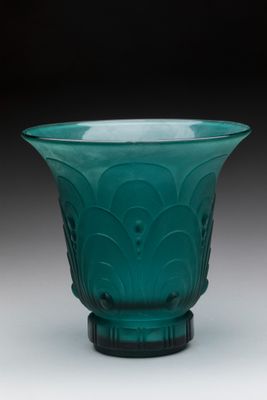 an image of a green glass bowl sitting on top of a table