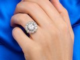 someone is wearing a ring with a large diamond on it