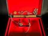 a red box that has a bunch of jewelry inside of it