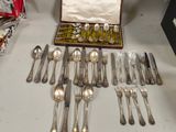 a lot of silverware sitting on a table