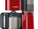 red coffee maker with a glass carafeo in front of it