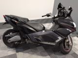 a picture of a black motorcycle parked on a checkered floor