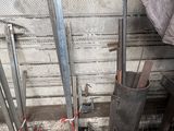 a pile of metal pipes that are next to a wall