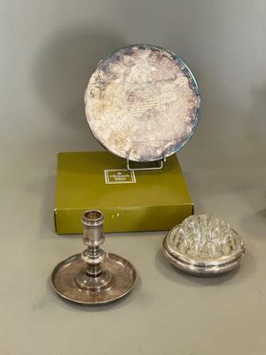 three silver objects sitting on a table next to a green box