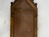 a small mirror hanging on the wall in the corner of the room