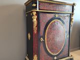 a cabinet that is sitting on the floor in a room