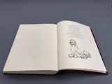 un livre ouvert sur lequel est dessiné un chien
