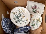 many plates and bowls in a cardboard box