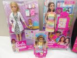 three barbie dolls are sitting next to each other on a table