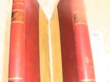 two red books sitting on top of a table