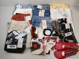 a lot of clothing and accessories laid out on a table