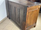 an old wooden chest with a door on top of it