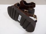 pair of brown leather sandals with buckles on a white surface