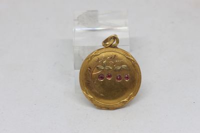 an image of a gold locke with a pink stone in the center