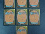 four decks of magic the gathering cards are arranged on a table