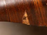 an old wooden table with a piece of wood sticking out of it