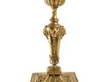 an image of a brass candle holder on a white background