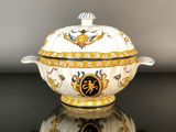 a close up of a bowl with a lid on a table